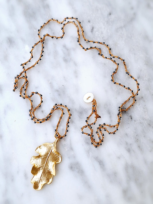 Crochet long necklace with gold plated oak leaf pendant