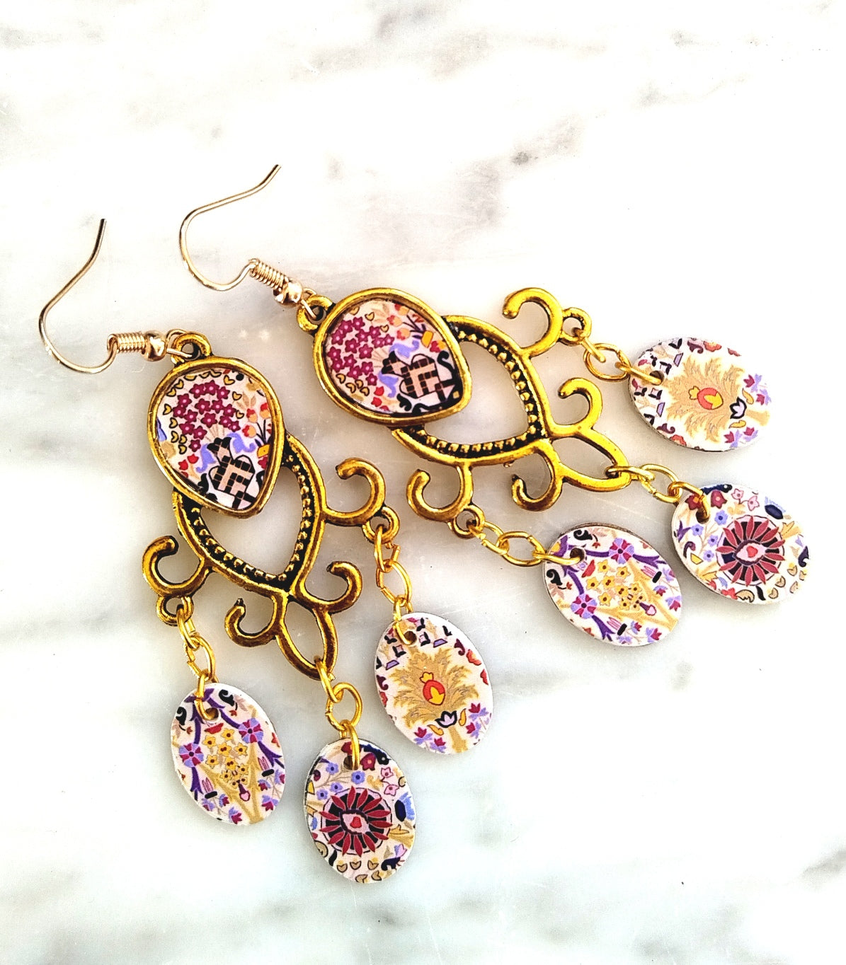 Gold coloured earrings with tapestry dangles